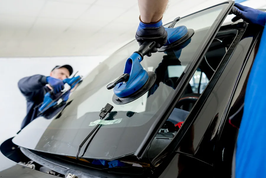 Windshield replacement on a blue car by a Middle Tennessee Auto Glass technician.